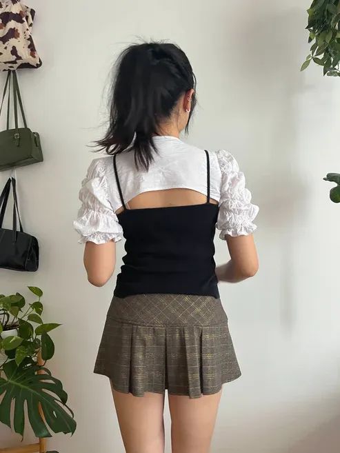 Back view of the Dahlia Bolero in white fabric modelled on the pattern designer.