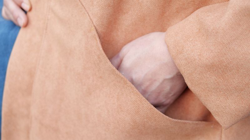 A close-up image of a hand entering a pocket in Sanae Ishida's Draft and Sew the Hanten Coat class on Creativebug