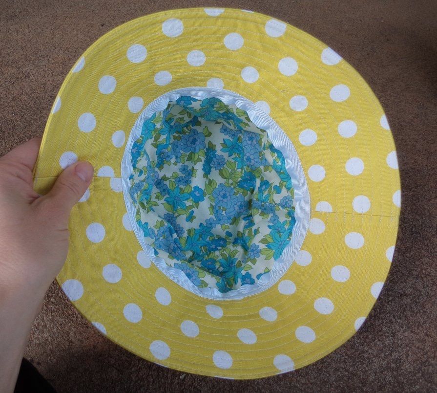 The interior is a floral blue fabric bordered by a white ribbon.
