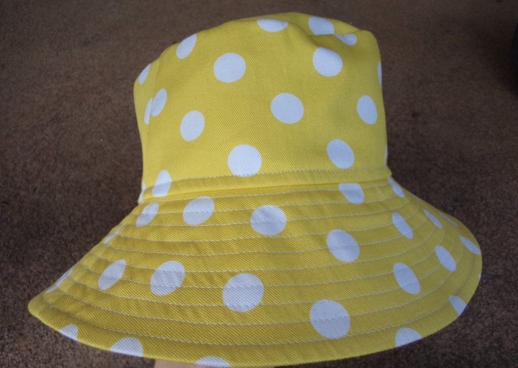 Yellow hat with big white polka dots
